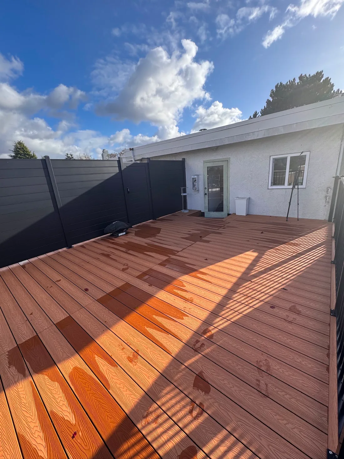 Brown composite deck boards with finished privacy panels
