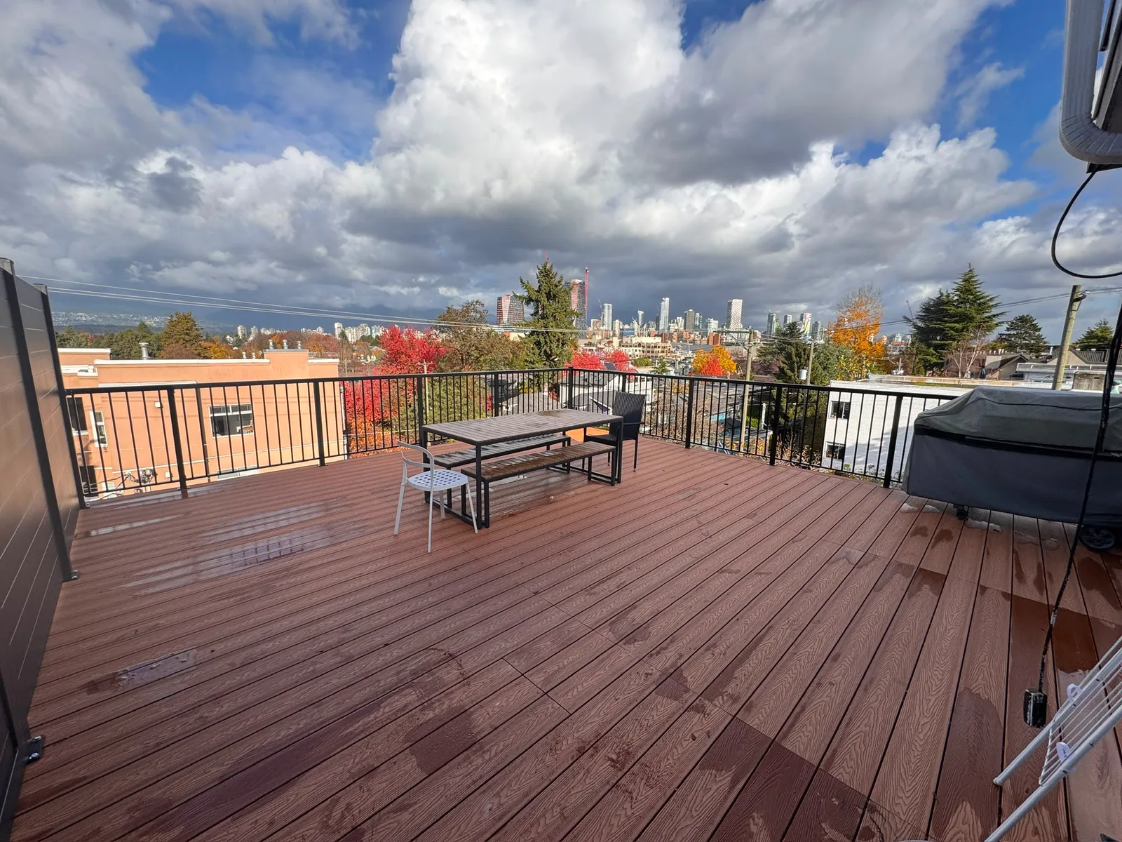 Finished brown composite rooftop deck overlooking Vancouver